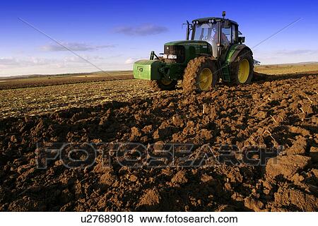 Tractor tilling the land View Large Photo Image Stock Photo - Tractor tilling the land. Fotosearch