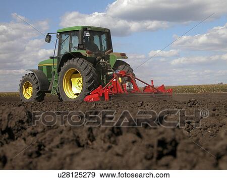 Stock Photo - Tractor tilling the land. Fotosearch