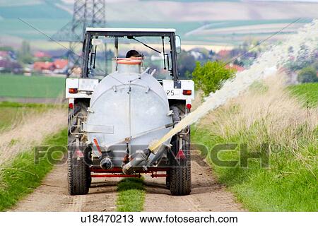 Tractor with sprayer wagon View Large Photo Image Stock Image - Tractor with sprayer wagon. Fotosearch