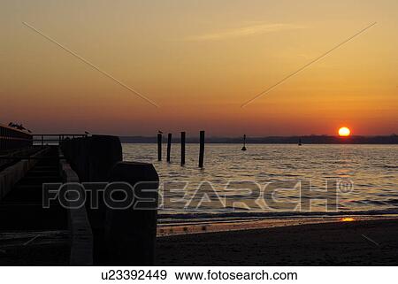 sunset glow, sunset, evening-sun, setting sun, stairway, buoy, surge View Large Photo Image Stock Photo - sunset glow, sunset, evening-sun, setting sun, stairway, buoy, surge. Fotosearch