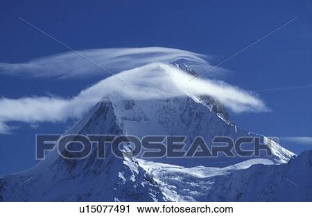 Clouds on a snowy mountain top View Large Photo Image Stock Image - Clouds on a snowy mountain top. Fotosearch