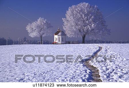 Stock Image - Snow covered footpath to church . Fotosearch