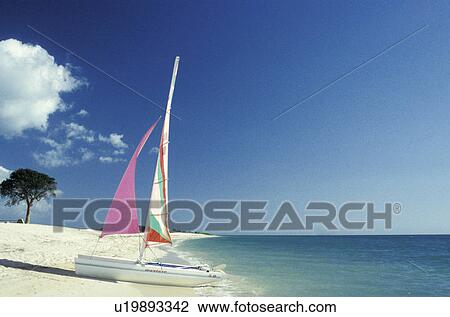 Sailboat on tropical beach View Large Photo Image Stock Image - Sailboat on tropical beach. Fotosearch