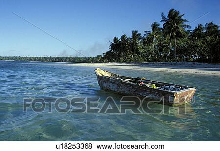 Stock Photo - Small boat anchored off beach. Fotosearch