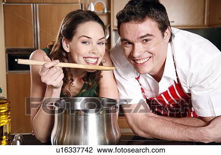A couple cooking together View Large Photo Image Stock Image - A couple cooking together. Fotosearch