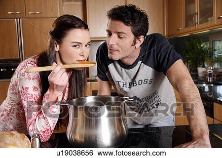 Stock Photograph - A couple cooking together. Fotosearch