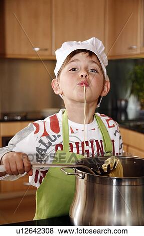 Boy cooking spaghetti View Large Photo Image Stock Photo - Boy cooking spaghetti. Fotosearch