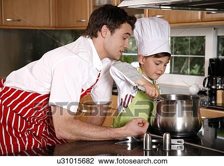 Stock Image - Father and son cooking. Fotosearch