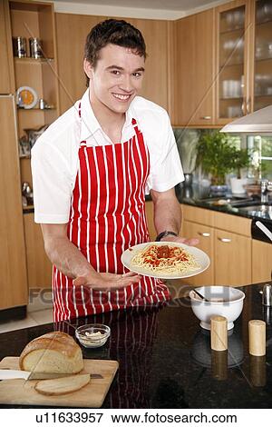 Man presenting a plate of spagetti View Large Photo Image Stock Photo - Man presenting a plate of spagetti. Fotosearch