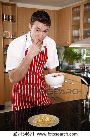Stock Image - Man tasting spaghetti sauce. Fotosearch