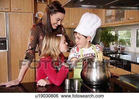 Mother and children cooking View Large Photo Image Stock Photograph - Mother and children cooking . Fotosearch