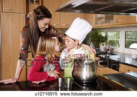 Stock Photography - Mother and children cooking . Fotosearch