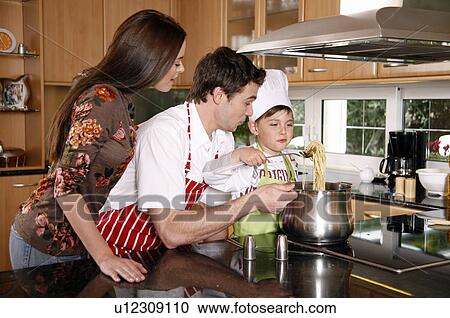 Parents and son cooking spaghetti View Large Photo Image Stock Image - Parents and son cooking spaghetti. Fotosearch