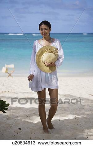 A young woman standing at beach View Large Photo Image Stock Image - A young woman standing at beach. Fotosearch