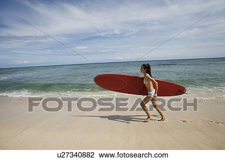 Portrait of a young woman running on beach View Large Photo Image Stock Image - Portrait of a young woman running on beach. Fotosearch