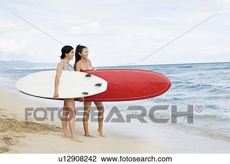 Profile of young women with surfboards at beach View Large Photo Image Stock Image - Profile of young women with surfboards at beach. Fotosearch