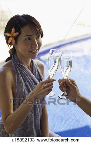 Stock Image - A woman toasting wineglass. Fotosearch
