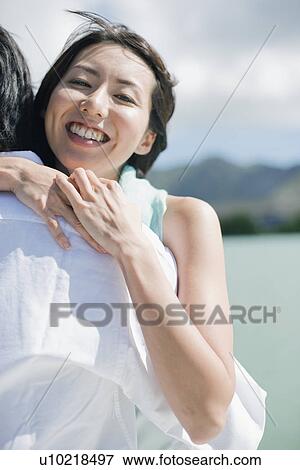 A young couple hugging each other View Large Photo Image Stock Photo - A young couple hugging each other. Fotosearch