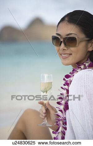 A young woman holding wineglass smiling View Large Photo Image Stock Photography - A young woman holding wineglass smiling. Fotosearch