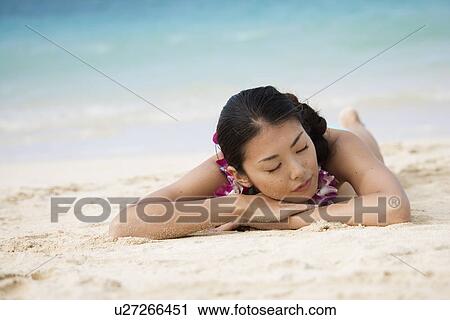 A young woman sleeping on sand at beach View Large Photo Image Stock Image - A young woman sleeping on sand at beach. Fotosearch