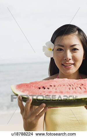Portrait of a young woman holding watermelon View Large Photo Image Picture - Portrait of a young woman holding watermelon. Fotosearch