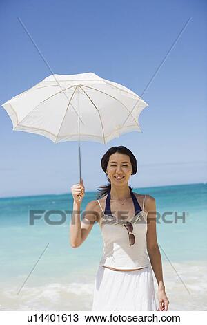 Portrait of a young woman holding umbrella View Large Photo Image Stock Image - Portrait of a young woman holding umbrella. Fotosearch