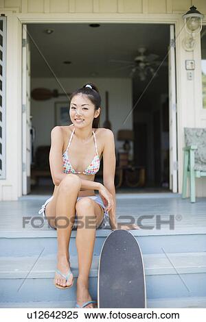 Portrait of a young woman sitting on steps View Large Photo Image Stock Photography - Portrait of a young woman sitting on steps. Fotosearch