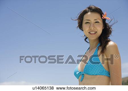 Stock Photo - Portrait of a young woman smiling. Fotosearch