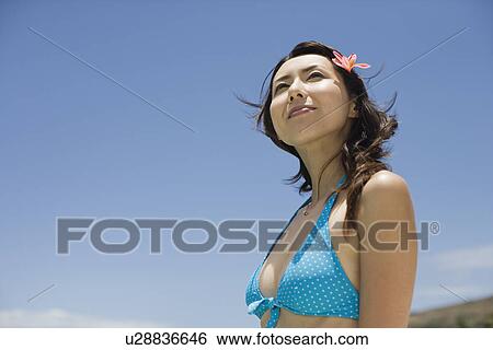Stock Photograph - Side view of a woman smiling. Fotosearch
