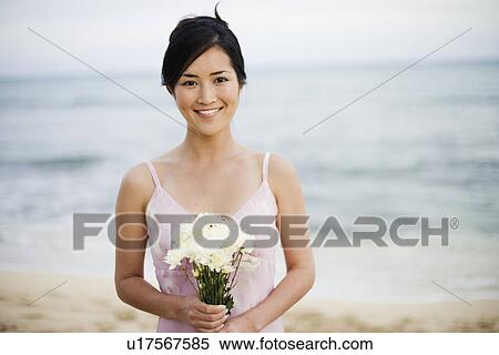 View of a young woman with bouquet of flowers View Large Photo Image Stock Photography - View of a young woman with bouquet of flowers. Fotosearch