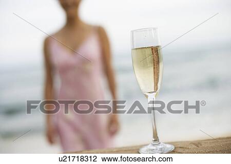 Stock Image - Close-up of a wineglass on sand. Fotosearch