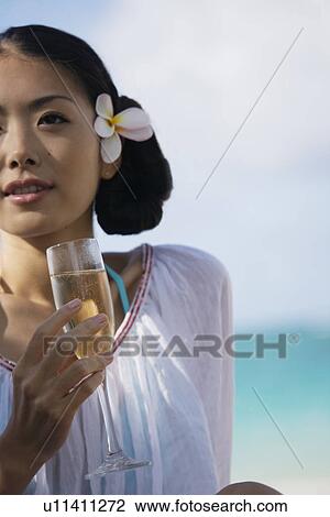 Close-up of young woman holding wineglass View Large Photo Image Stock Image - Close-up of young woman holding wineglass. Fotosearch