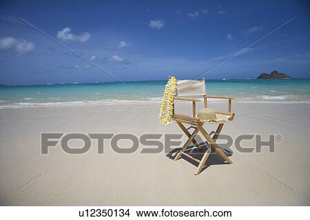 View of a garland and hat on wooden chair at beach View Large Photo Image Picture - View of a garland and hat on wooden chair at beach. Fotosearch