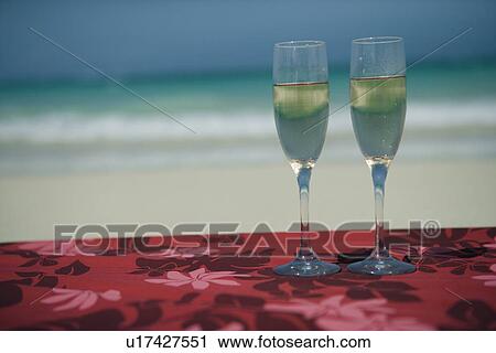 Wine glasses filled with drink in foreground View Large Photo Image Stock Image - Wine glasses filled with drink in foreground. Fotosearch