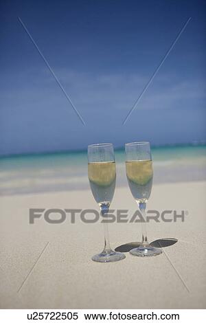 Wineglasses filled with drink in foreground View Large Photo Image Stock Photography - Wineglasses filled with drink in foreground. Fotosearch
