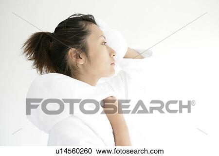 A young woman in bathrobe wipes her hair after a shower View Large Photo Image Stock Image - A young woman in bathrobe wipes her hair after a shower. Fotosearch