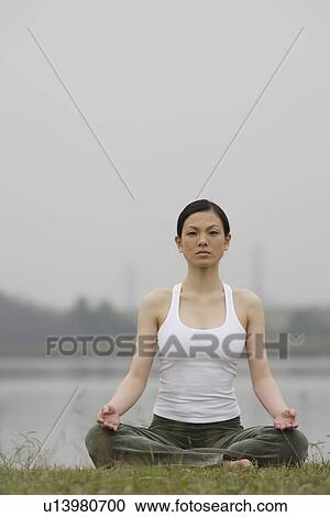 Front view of a woman in lotus position View Large Photo Image Stock Image - Front view of a woman in lotus position. Fotosearch