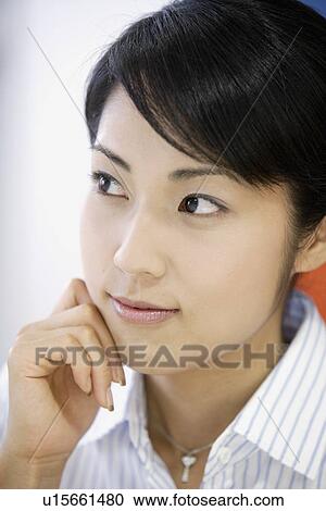 A woman lost in her thoughts as she looks outside the window View Large Photo Image Stock Image - A woman lost in her thoughts as she looks outside the window. Fotosearch
