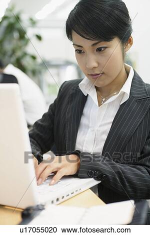 A woman working on the laptop in her office View Large Photo Image Stock Image - A woman working on the laptop in her office. Fotosearch