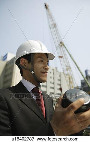 Businessman with a hard hat, portrait View Large Photo Image Stock Photo - Businessman with a hard hat, portrait. Fotosearch