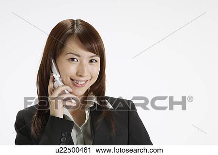 Businesswoman conversing on a cellphone, portrait View Large Photo Image Stock Image - Businesswoman conversing on a cellphone, portrait. Fotosearch