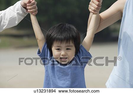 Picture - A boy between mother and father. Fotosearch