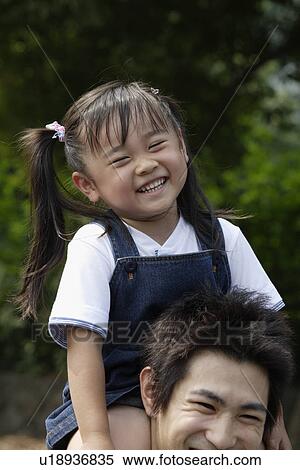 A girl on her father's shoulder View Large Photo Image Stock Photography - A girl on her father's shoulder. Fotosearch