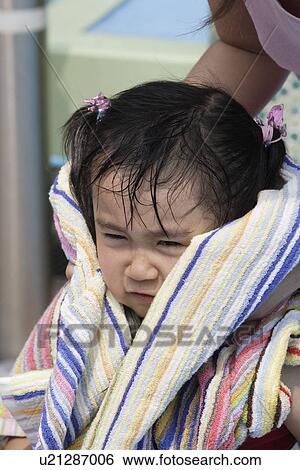 Stock Photograph - A mother towels her daughter's hair. Fotosearch