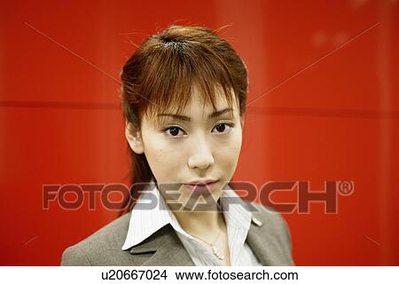 Picture - A businesswoman looking at the camera. Fotosearch