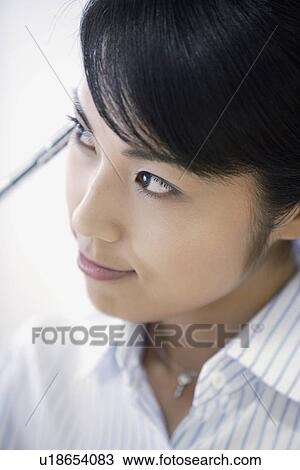 A woman lost in her thoughts as she looks outside the window View Large Photo Image Stock Image - A woman lost in her thoughts as she looks outside the window. Fotosearch