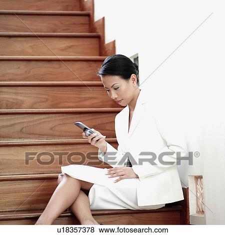 Stock Photo - Businesswoman operating a mobile phone. Fotosearch