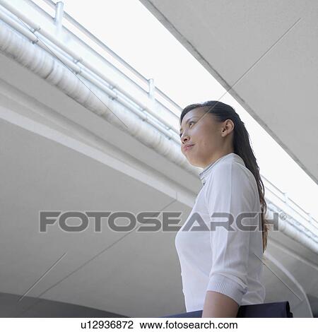 Stock Image - Low angle view of a businesswoman. Fotosearch