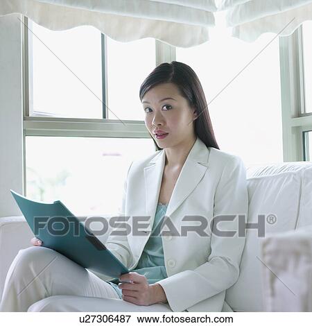 Stock Photo - Portrait of a businesswoman holding a file. Fotosearch