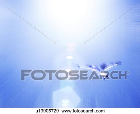 Stock Photo - View of bird flying against sun (digital composite). Fotosearch